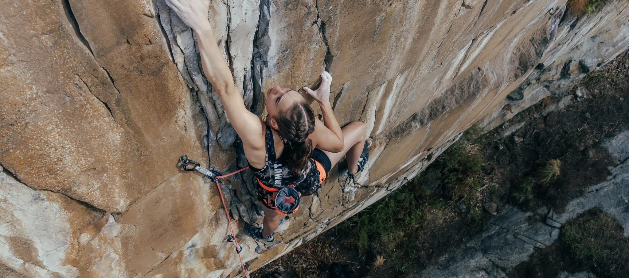 A climber scales a steep cliff face